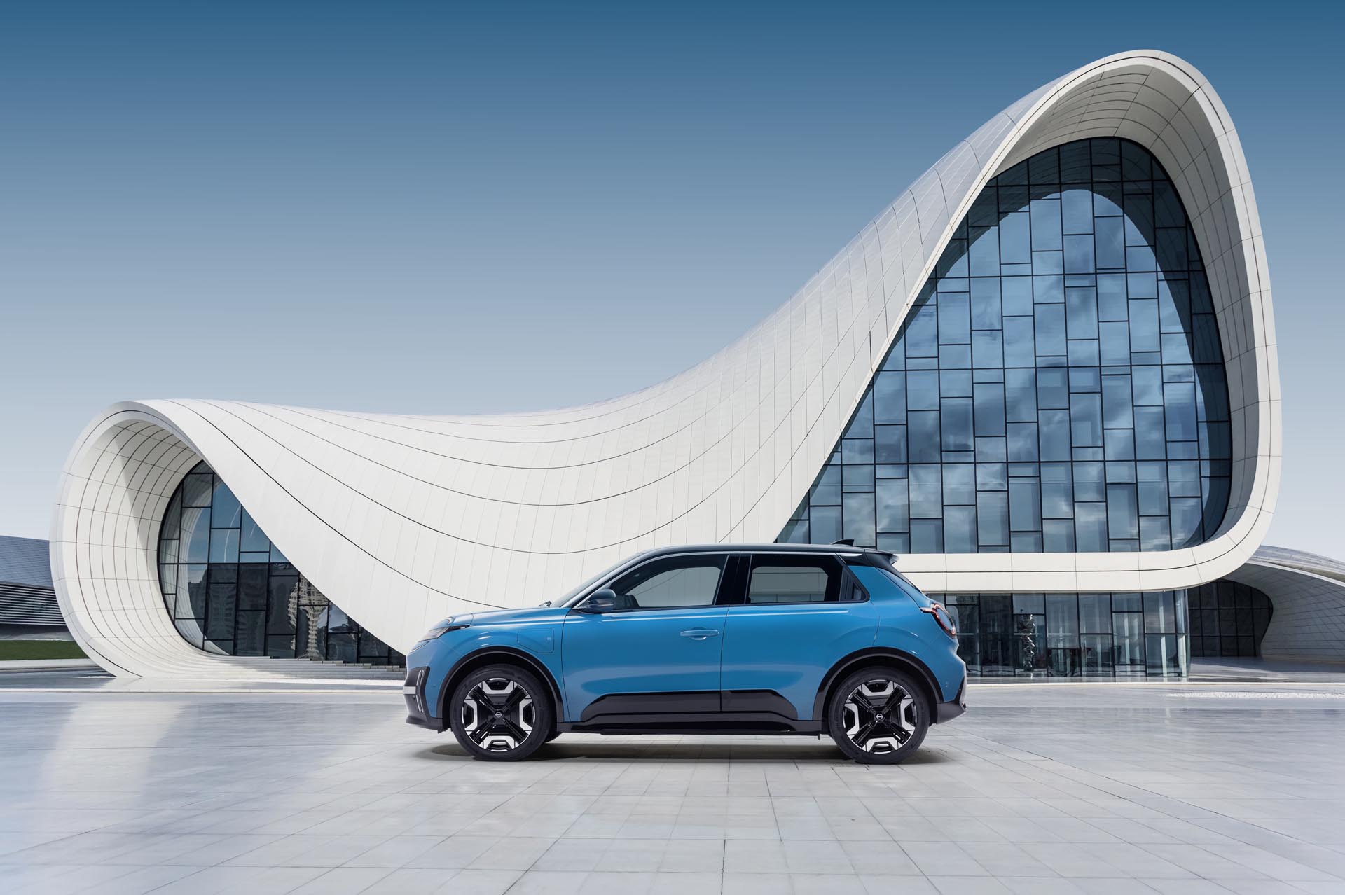 Hero image of gear blue Micra profile against a design architectural building