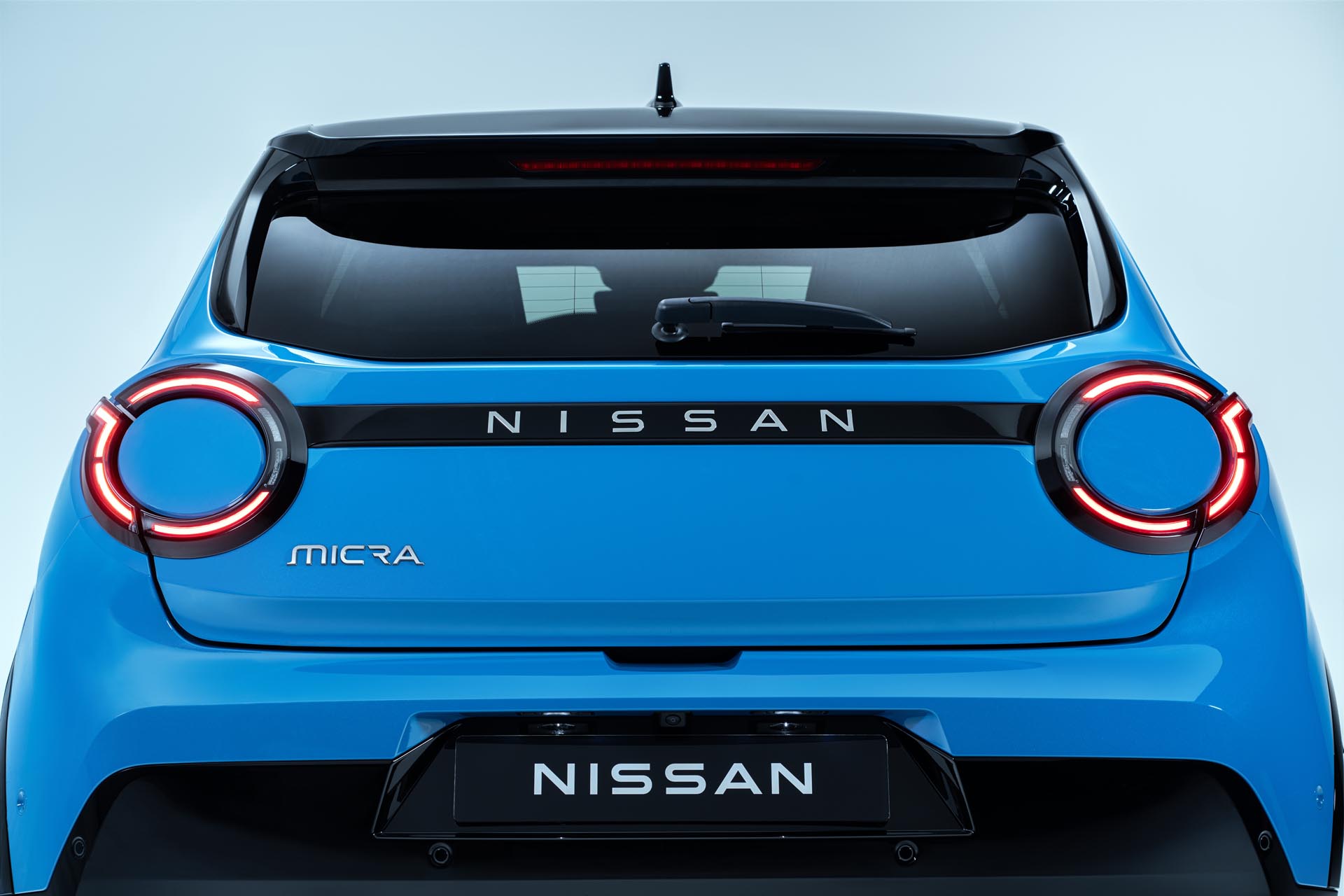 Rear view of Micra showing rear headlamps Micra logo Nissan logo and trunk door