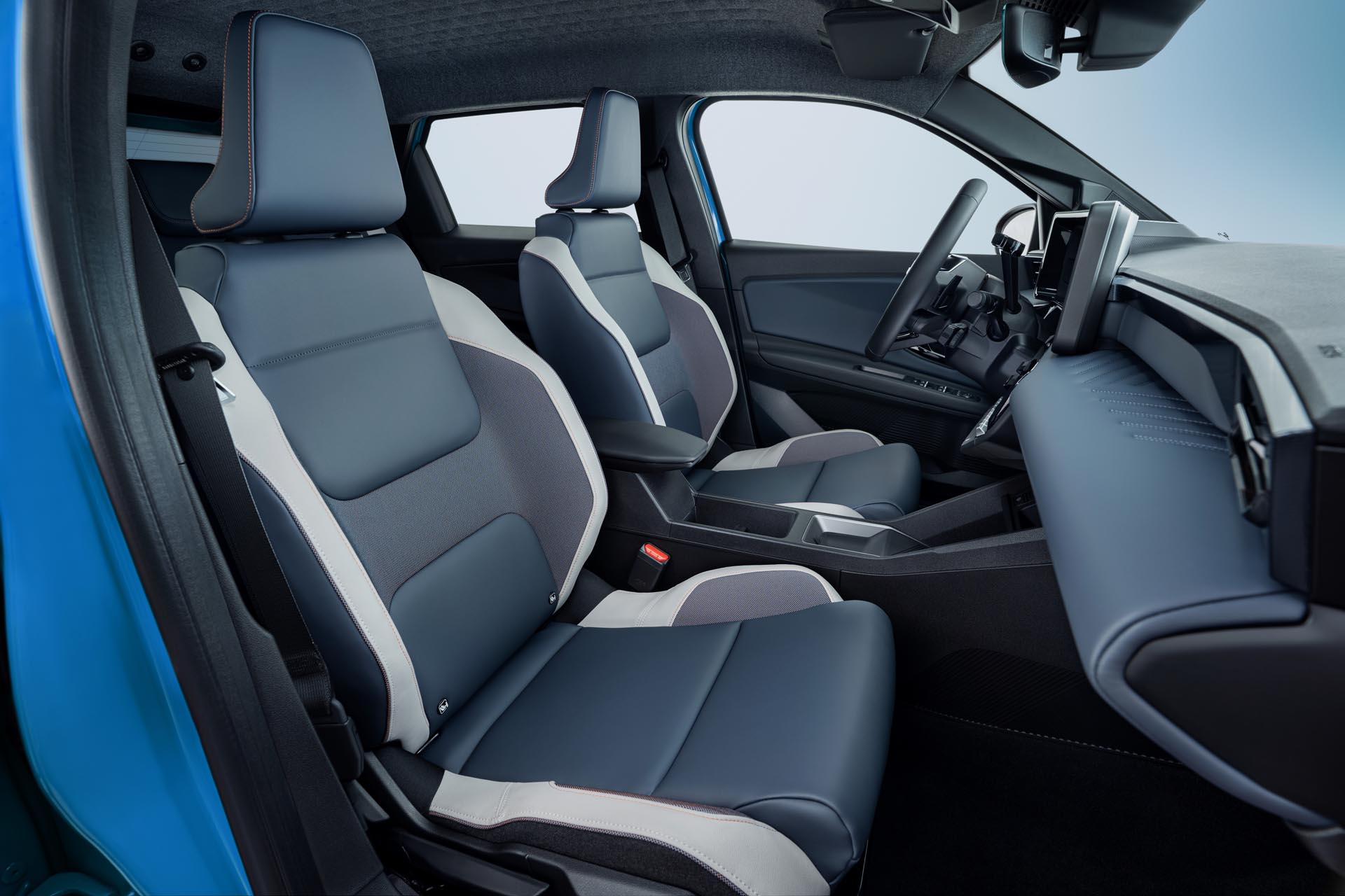 Side view of Micra front seats from passenger side door pov revealing leather materials steering wheel and dashboard