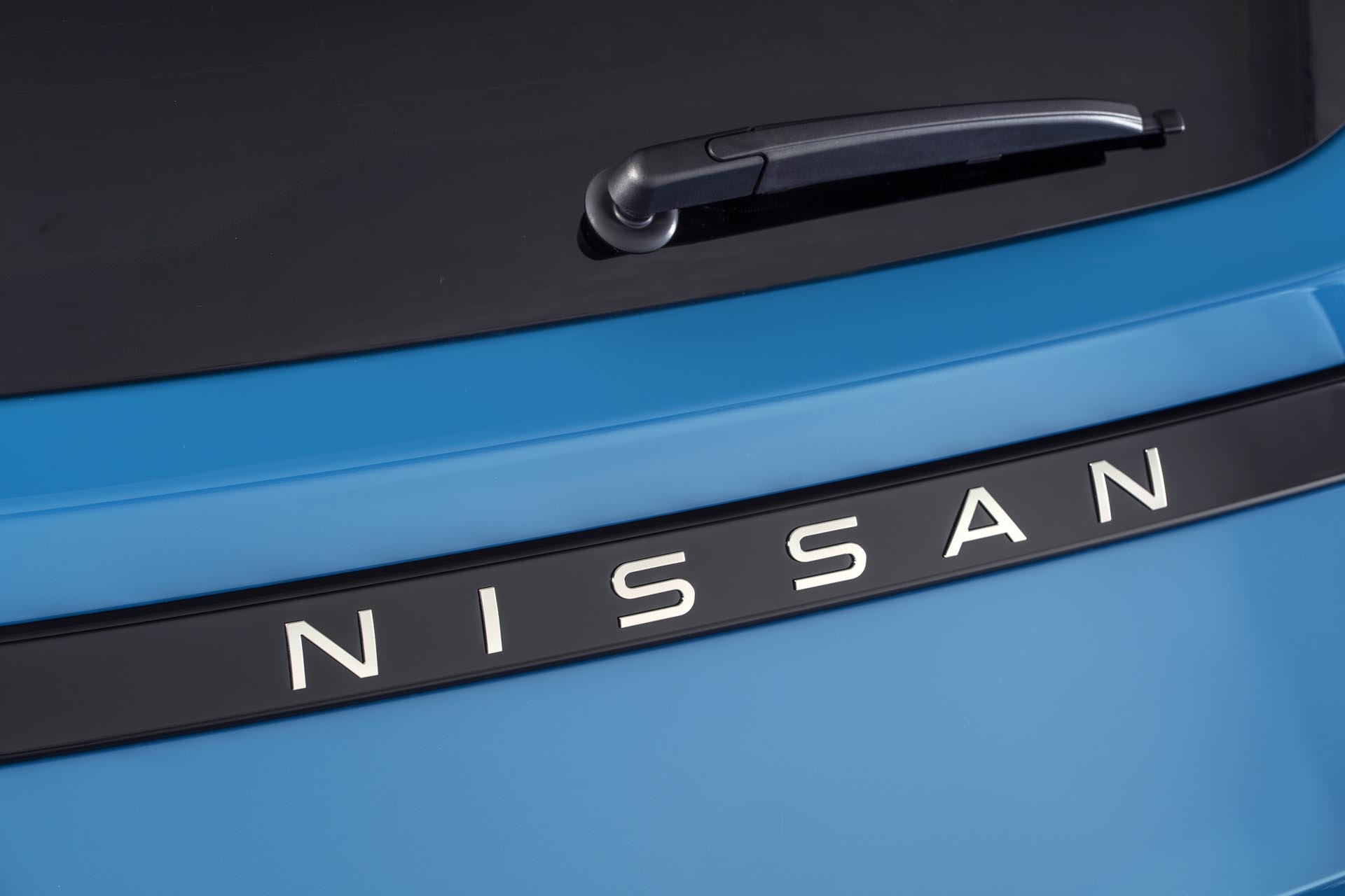 detailed image of NISSAN name plate on rear body of Micra